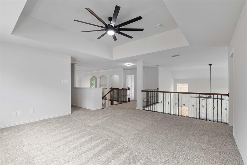 11984 Del Rio Drive Frisco, TX 75035 - Photo 22 of 38 Empty room featuring baseboards, a raised ceiling, a ceiling fan, and carpet flooring