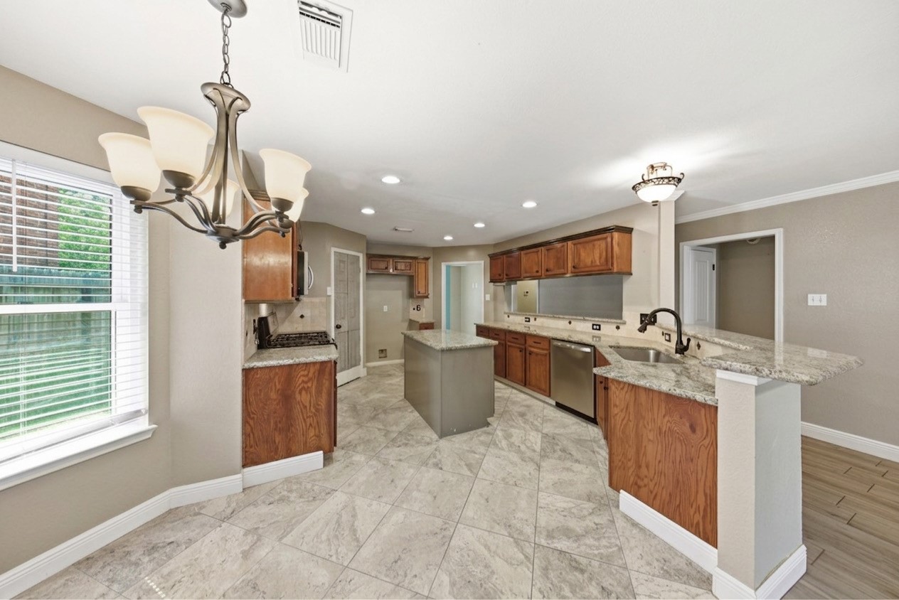 13506 Spring Court Tomball, TX 77375 - Photo 7 of 37 a kitchen with a sink appliances and cabinets