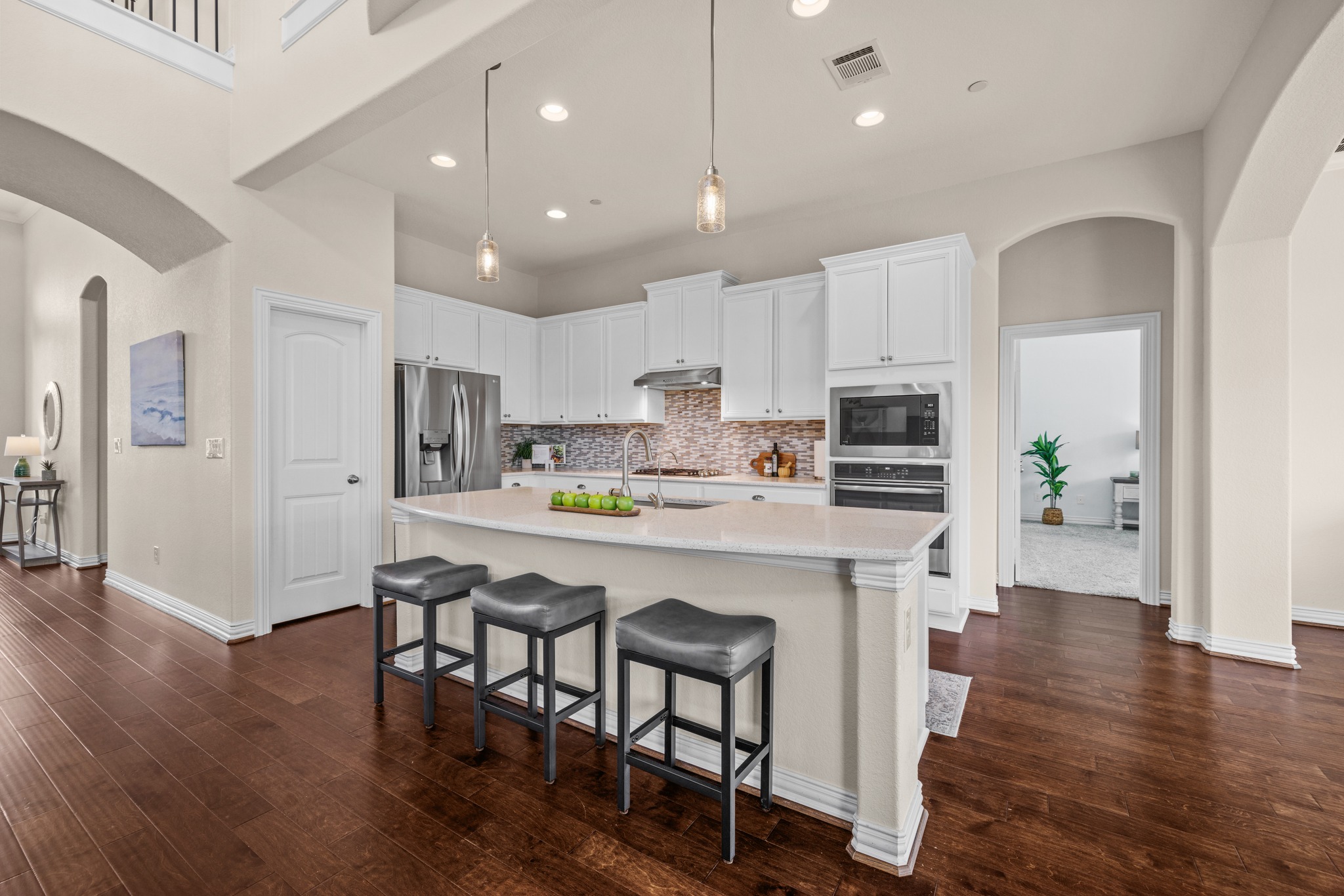 3914 Logan Ridge Drive Cedar Park, TX 78613 - Photo 13 of 40 a kitchen with stainless steel appliances a dining table chairs microwave and cabinets