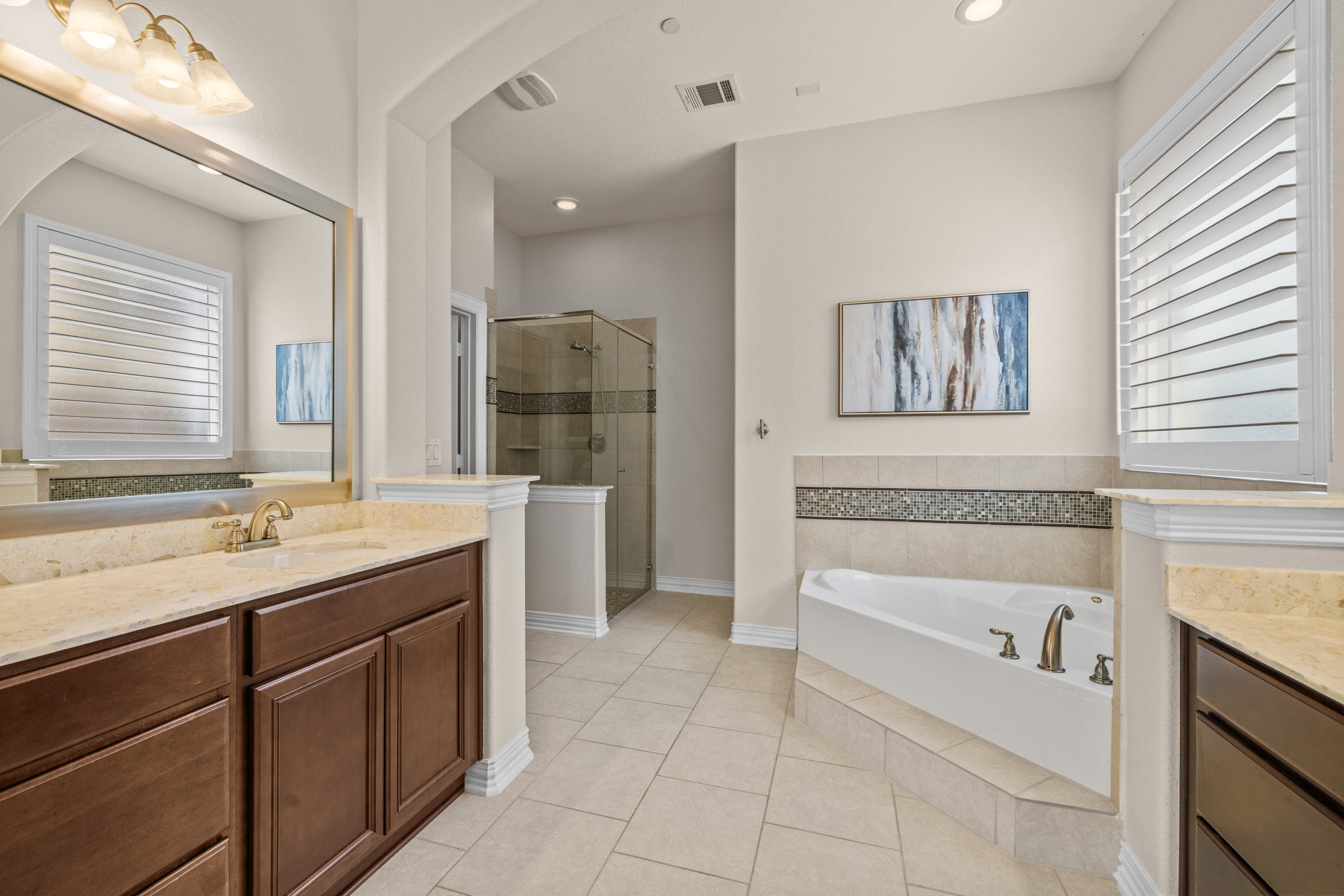 3914 Logan Ridge Drive Cedar Park, TX 78613 - Photo 22 of 40 a bathroom with a tub a sink and mirror