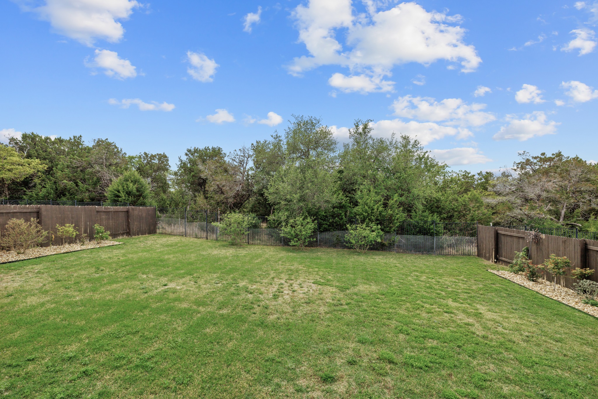 3914 Logan Ridge Drive Cedar Park, TX 78613 - Photo 39 of 40 a backyard of a house with lots of green space