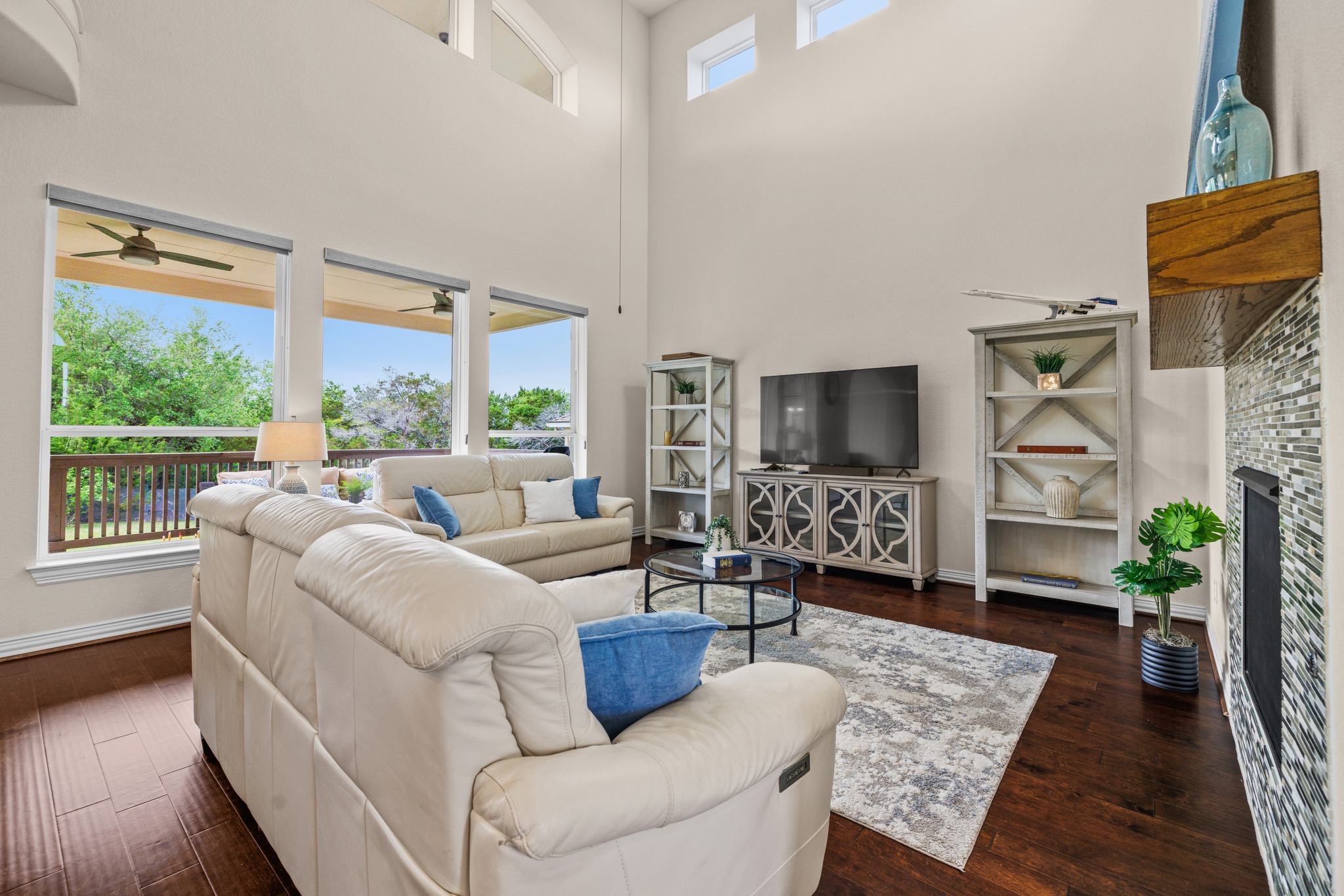 3914 Logan Ridge Drive Cedar Park, TX 78613 - Photo 10 of 40 a living room with furniture a flat screen tv and a floor to ceiling window