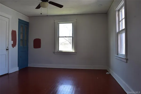 a view of room and hall with wooden floor