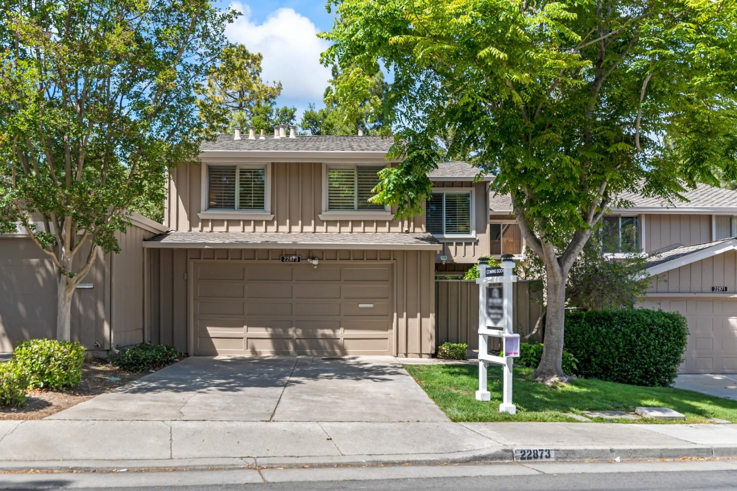 a front view of house with yard garage and furniture