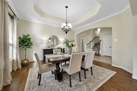 a view of a dining room with furniture and a chandelier
