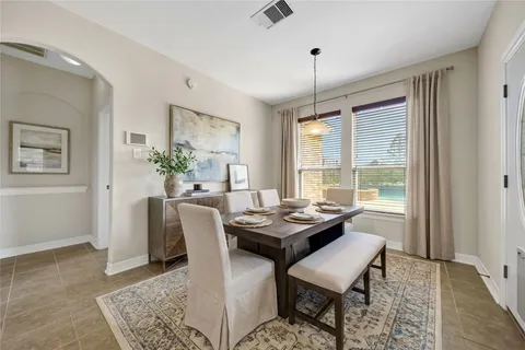 a dining room with furniture and window