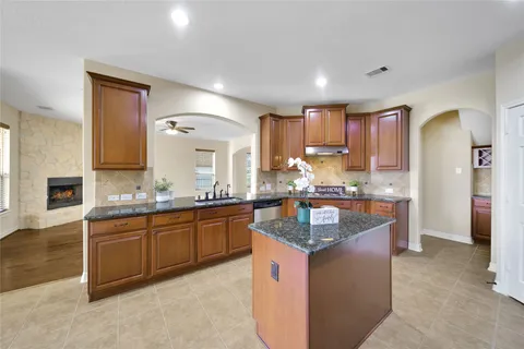a kitchen with granite countertop counter top space sink and stainless steel appliances