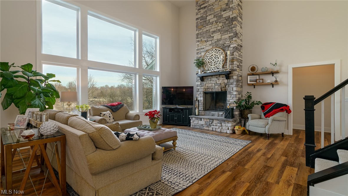 1849 Fixler Road Wadsworth, OH 44281 - Photo 20 of 39 Living room with plenty of natural light, dark hardwood / wood-style floors, a fireplace, and a high ceiling