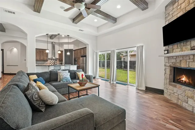 a living room with furniture fireplace and flat screen tv