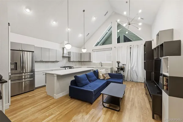 a kitchen with stainless steel appliances a stove a sink a refrigerator and cabinets