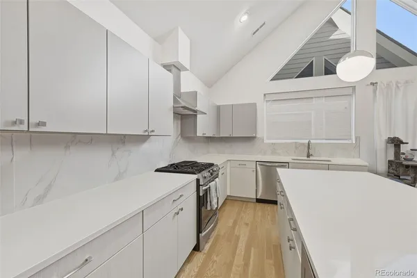 a kitchen with a stove and a refrigerator