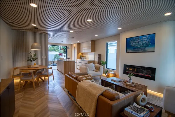 a living room with furniture kitchen view and a fireplace