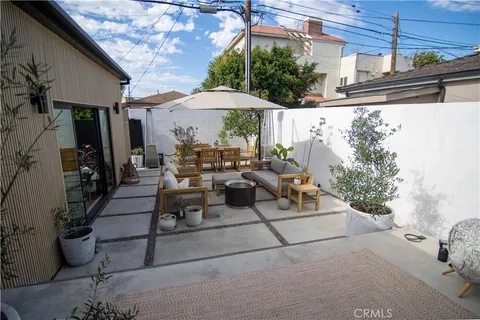 a view of a patio with table and chairs potted plants