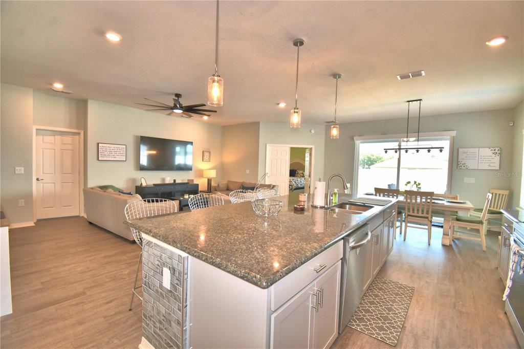4340 Reding Way Lakeland, FL 33813 - Photo 18 of 63 a large kitchen with kitchen island a large center island in it