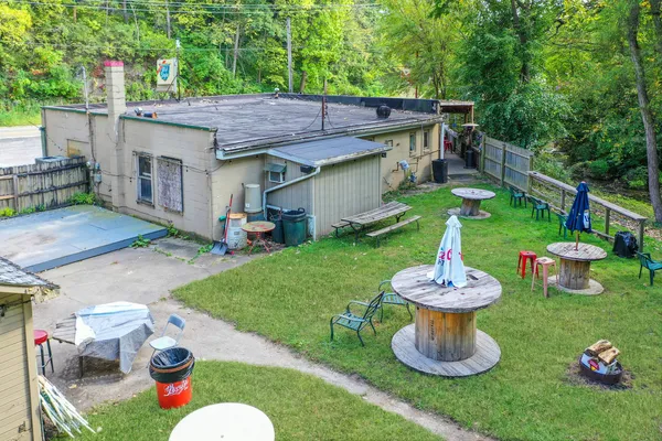 a backyard of a house with table and chairs