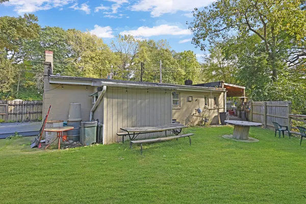 a wooden bench sitting in the grass