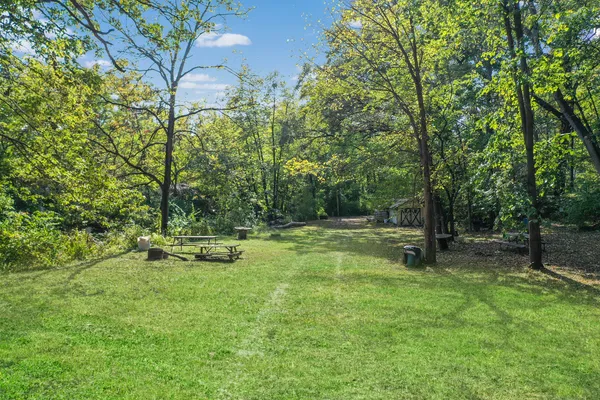 a view of a chair and table in the backyard