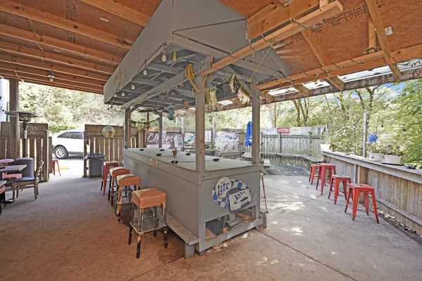 a view of a patio with table and chairs with wooden fence and plants