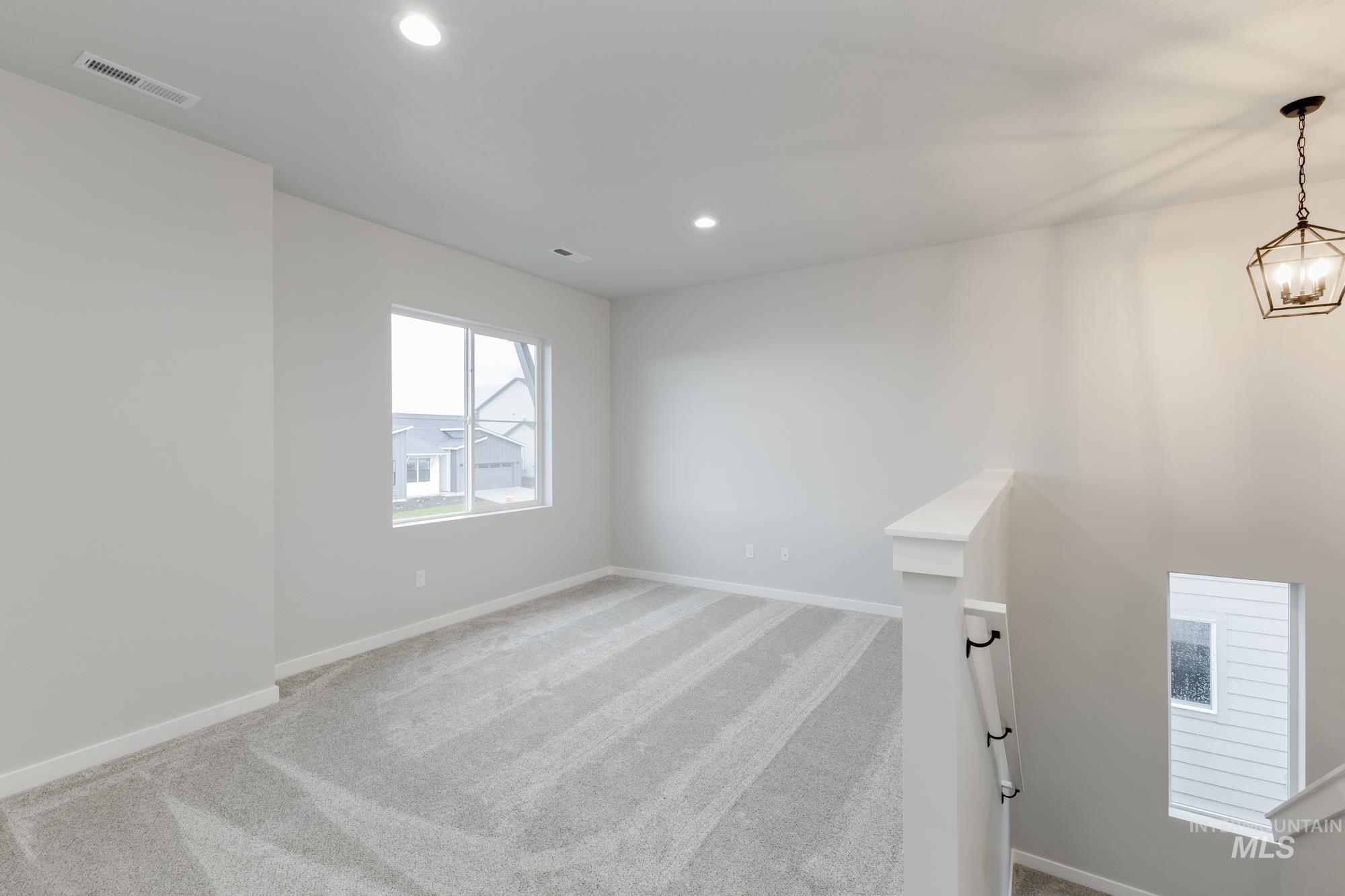 6494 South Sunfish Avenue Boise, ID 83709 - Photo 15 of 32 Spare room with light colored carpet and recessed lighting