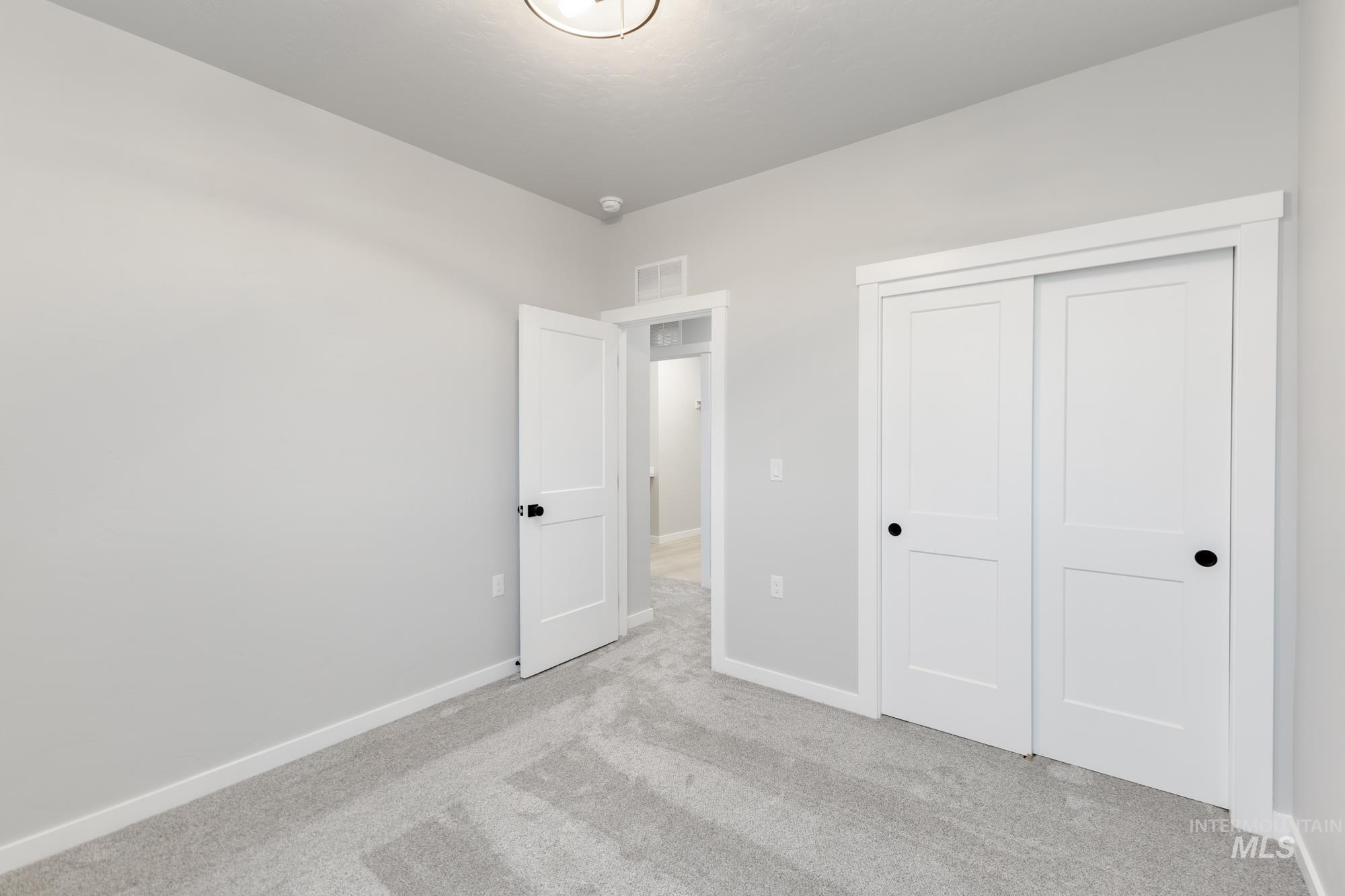 6494 South Sunfish Avenue Boise, ID 83709 - Photo 19 of 32 Unfurnished bedroom featuring carpet flooring and a closet