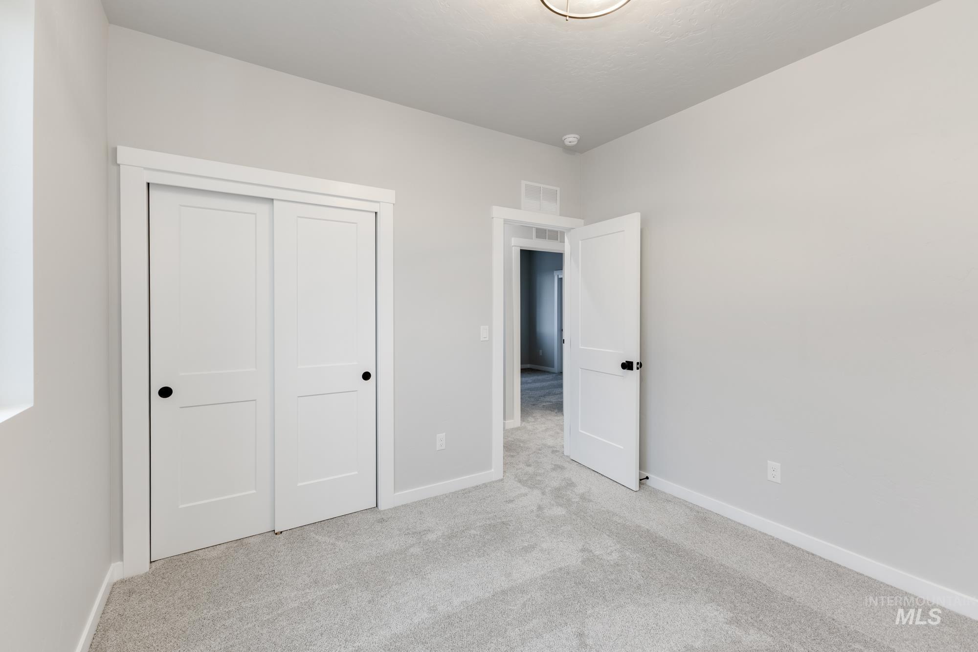 6494 South Sunfish Avenue Boise, ID 83709 - Photo 21 of 32 Unfurnished bedroom with light carpet and a closet