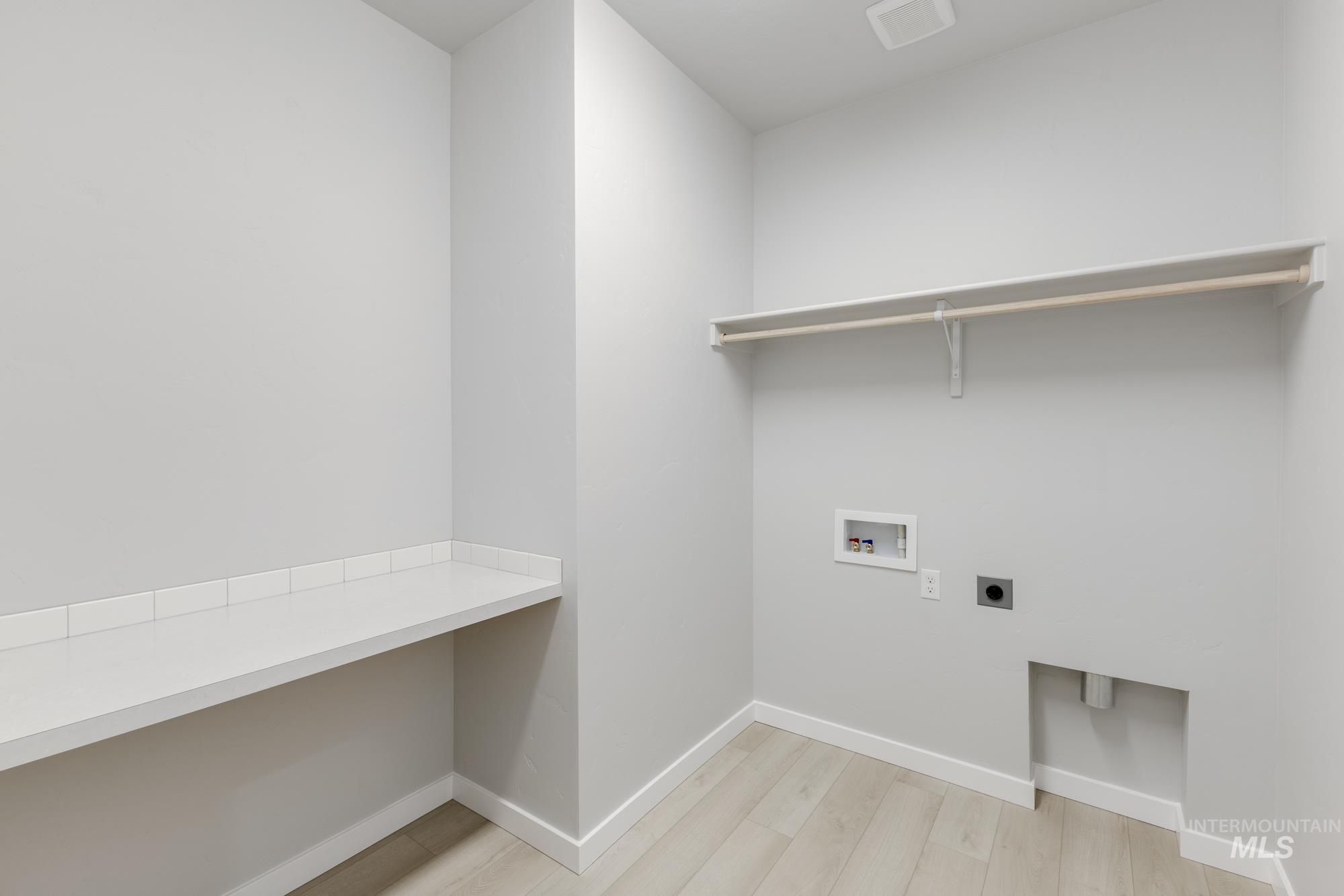6494 South Sunfish Avenue Boise, ID 83709 - Photo 22 of 32 Washroom featuring hookup for an electric dryer, washer hookup, and light wood finished floors