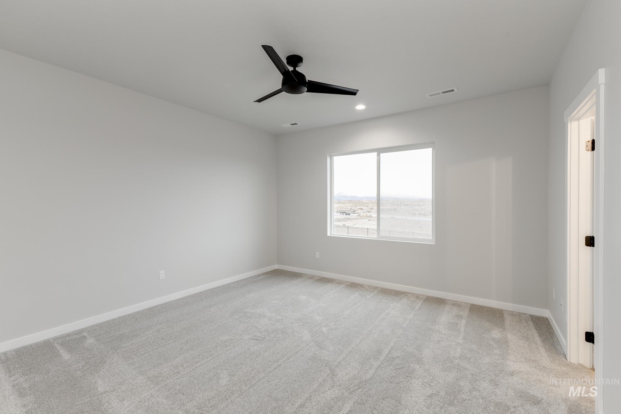6494 South Sunfish Avenue Boise, ID 83709 - Photo 24 of 32 Spare room with light colored carpet, ceiling fan, and recessed lighting