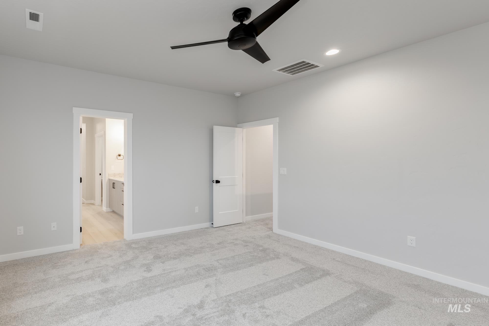 6494 South Sunfish Avenue Boise, ID 83709 - Photo 25 of 32 Unfurnished bedroom with light colored carpet, ceiling fan, ensuite bath, and recessed lighting