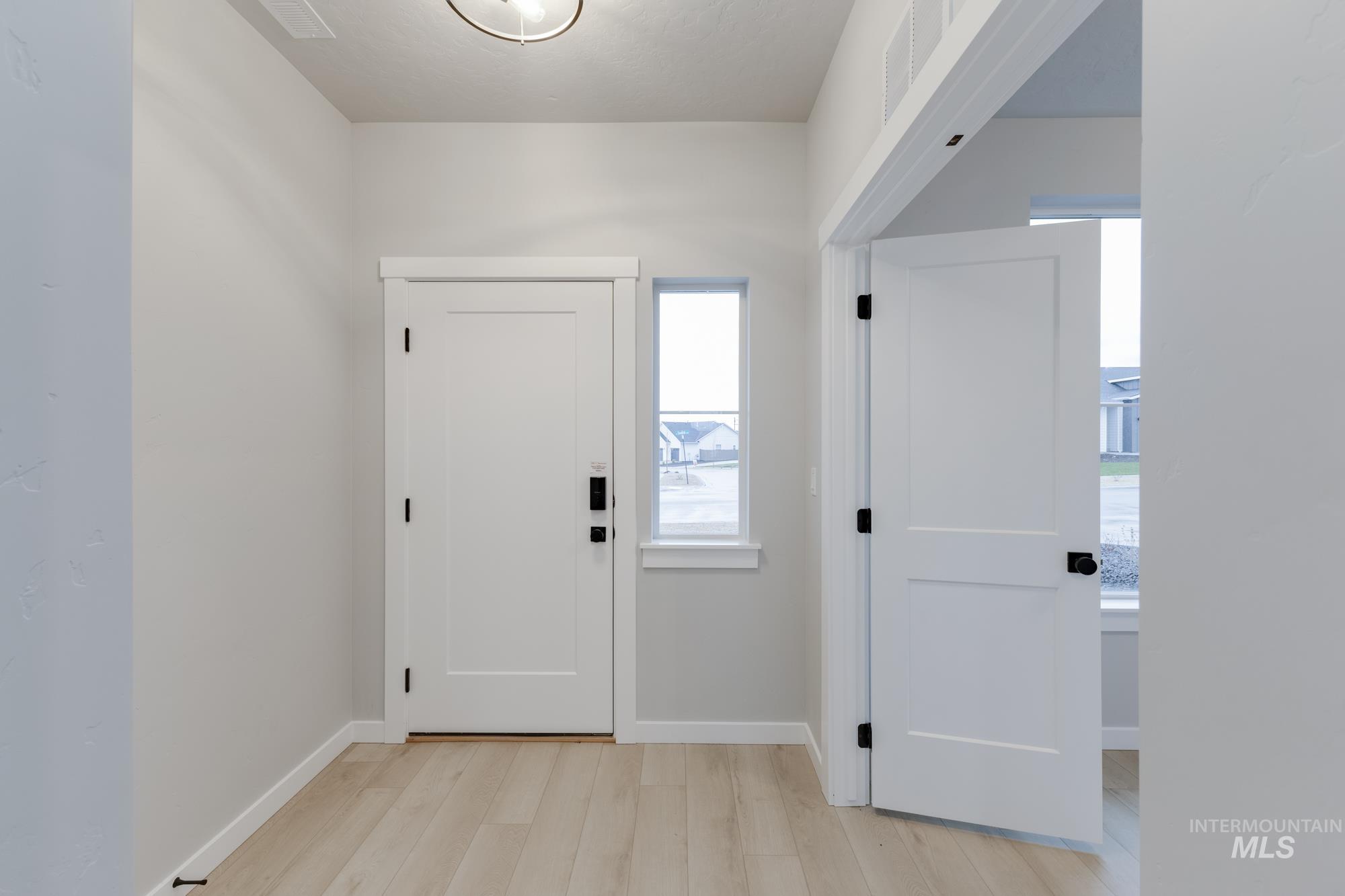 6494 South Sunfish Avenue Boise, ID 83709 - Photo 3 of 32 Entrance foyer featuring baseboards and light wood-type flooring