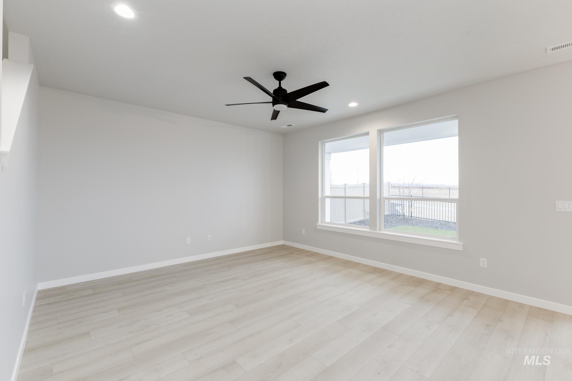 6494 South Sunfish Avenue Boise, ID 83709 - Photo 8 of 32 Unfurnished room with light wood-style floors, recessed lighting, and a ceiling fan