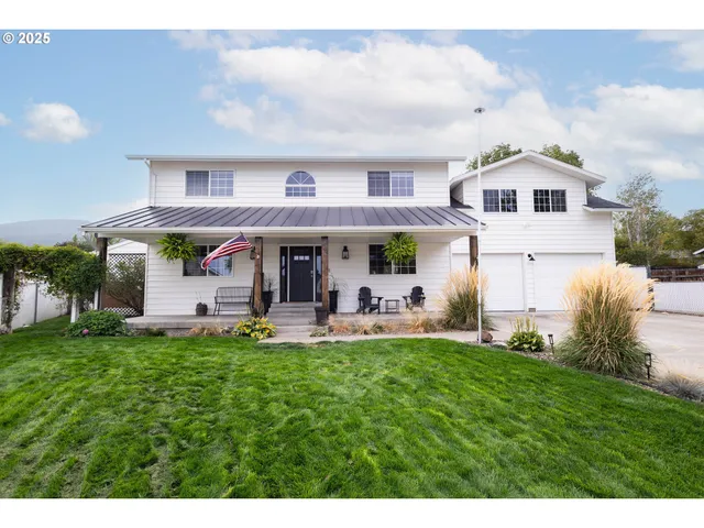 a view of a house with a yard porch and sitting area