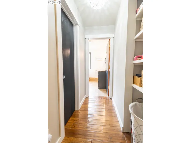 a view of a hallway with wooden floor
