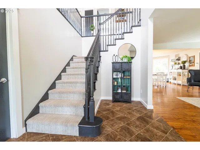 a view of entryway and hall with wooden floor
