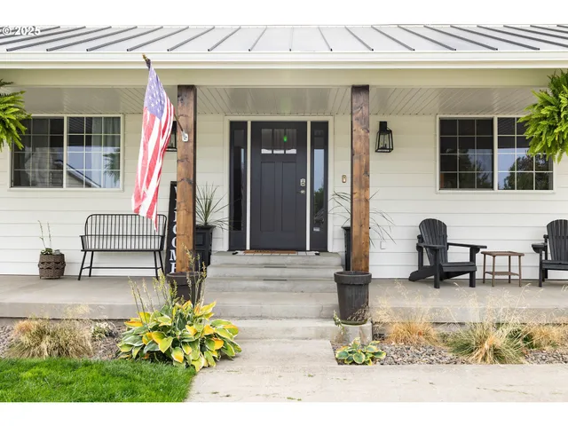 a front view of a house with swimming pool and glass windows