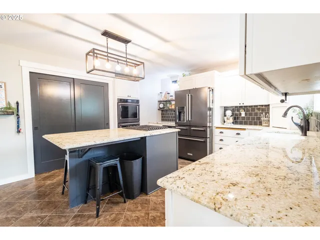a kitchen with refrigerator and cabinets
