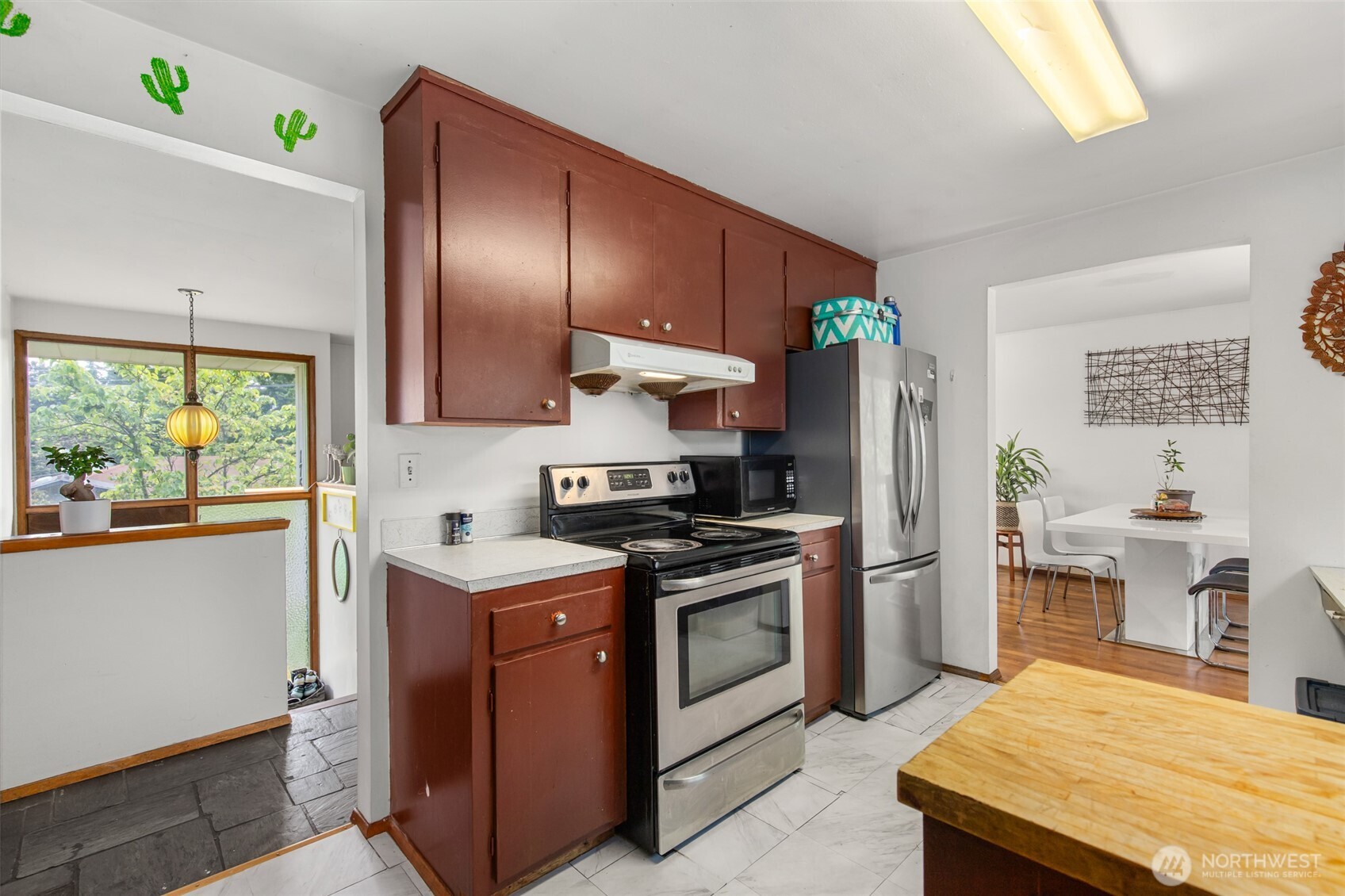 17543 7th Avenue Northeast Shoreline, WA 98155 - Photo 13 of 37 a kitchen with stainless steel appliances granite countertop a stove a refrigerator a sink a stove and island