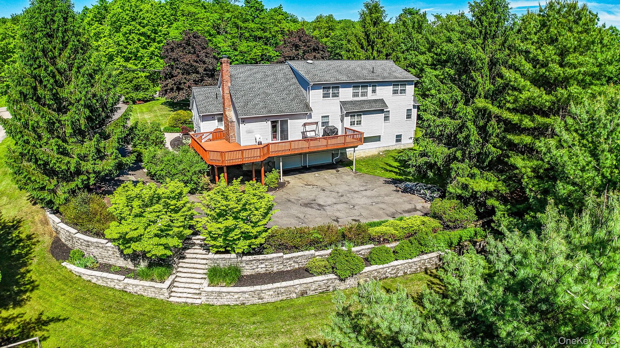 214 West Mombasha Road Monroe, NY 10950 - Photo 40 of 43 a backyard of a house with a yard and outdoor seating