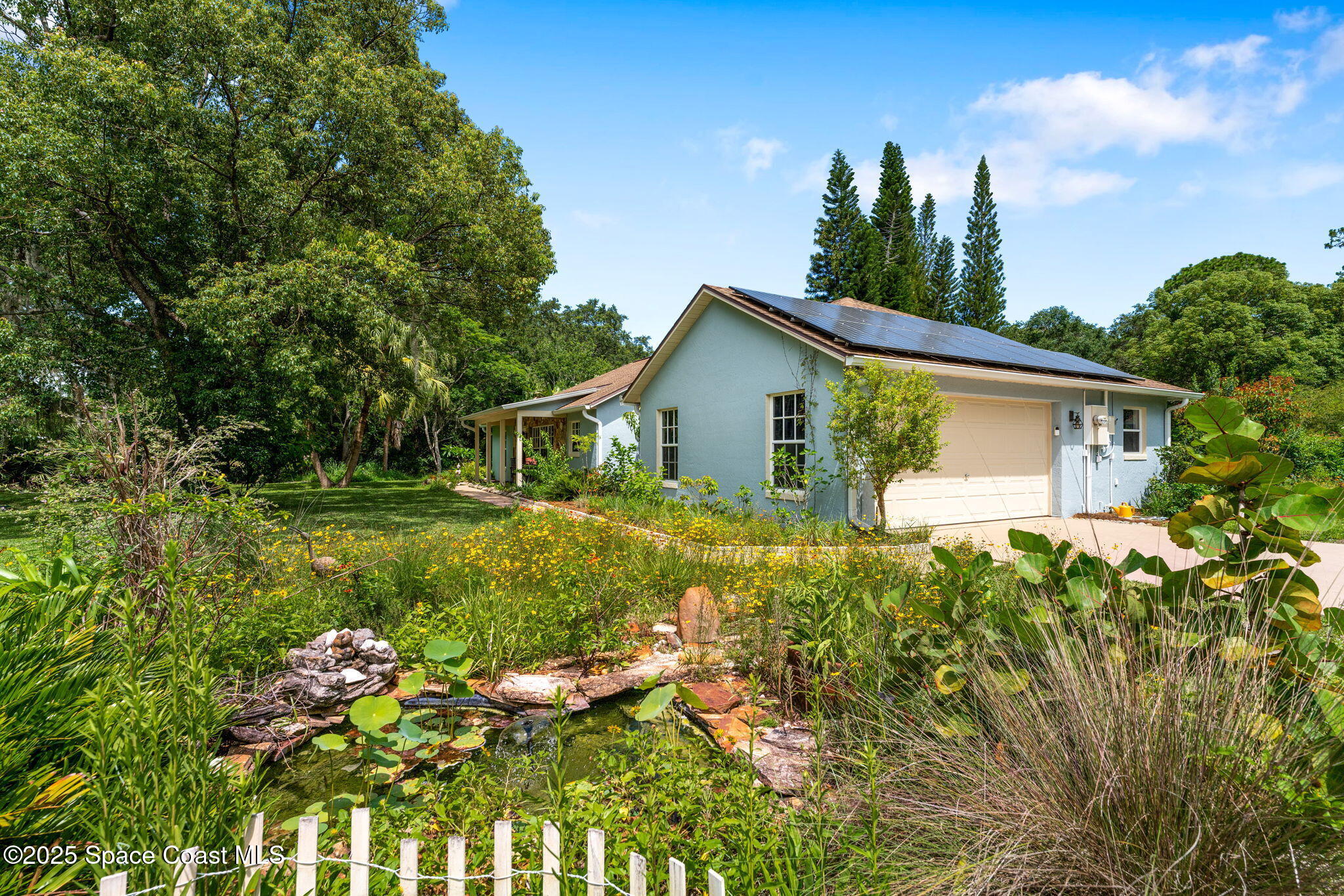 3565 Johns Road Mims, FL 32754 - Photo 3 of 52 Front/Side garage and garden