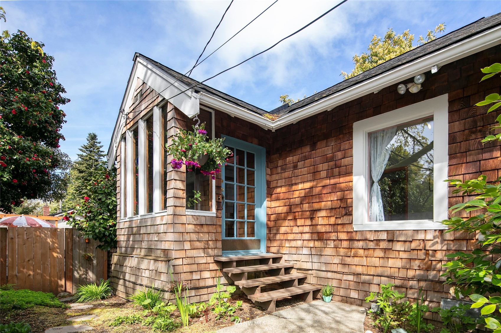 7141 47th Avenue Southwest Seattle, WA 98136 - Photo 1 of 27 a front view of a house with a garden