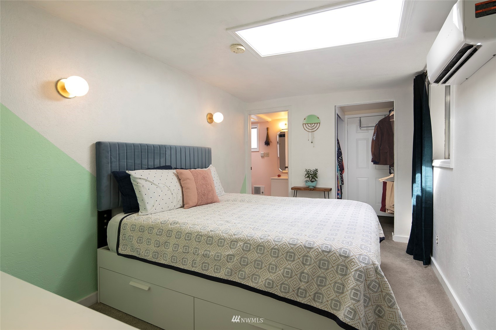 7141 47th Avenue Southwest Seattle, WA 98136 - Photo 13 of 27 a bedroom with a bed and a mirror