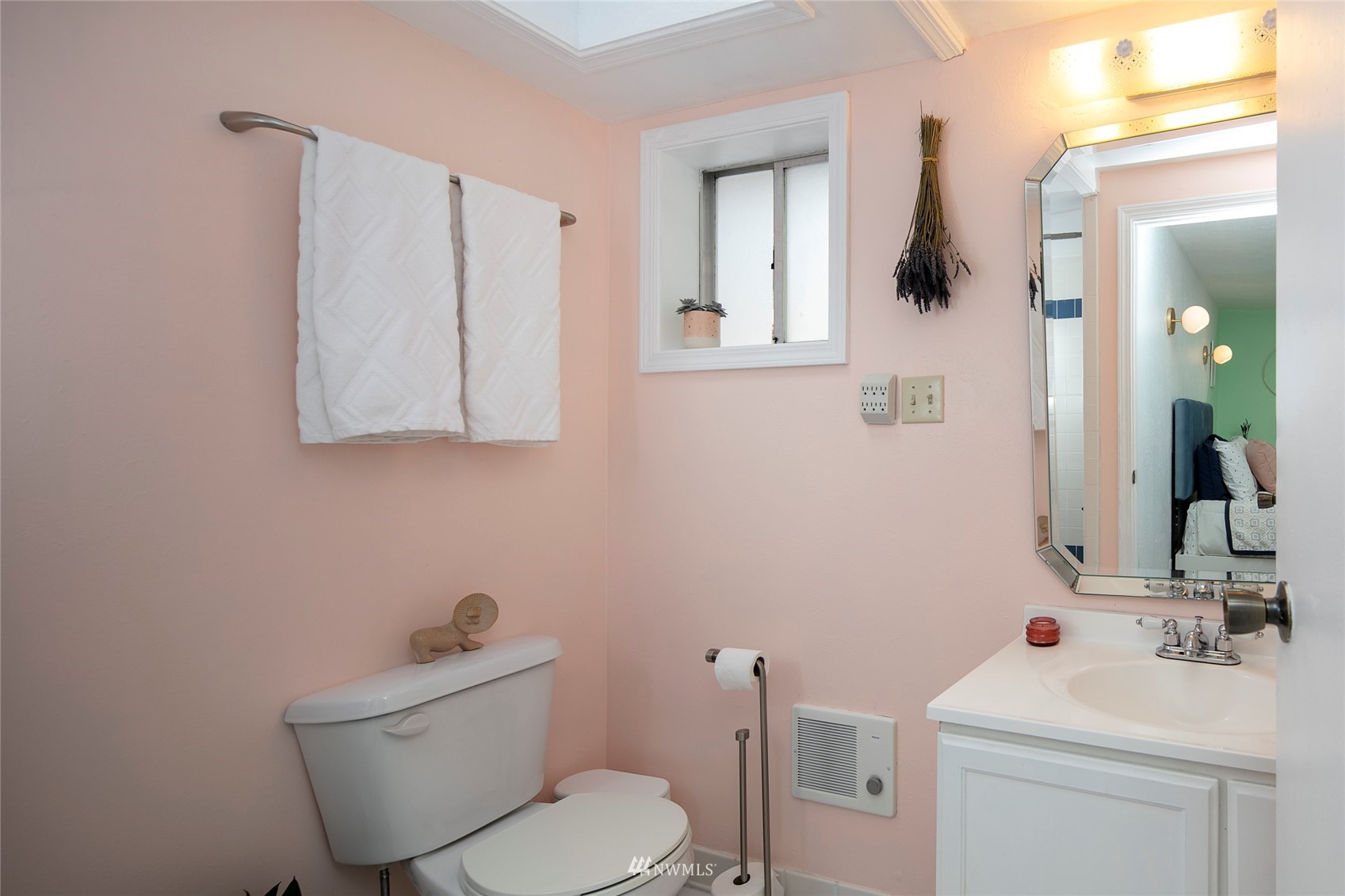 7141 47th Avenue Southwest Seattle, WA 98136 - Photo 14 of 27 a bathroom with a toilet sink and mirror