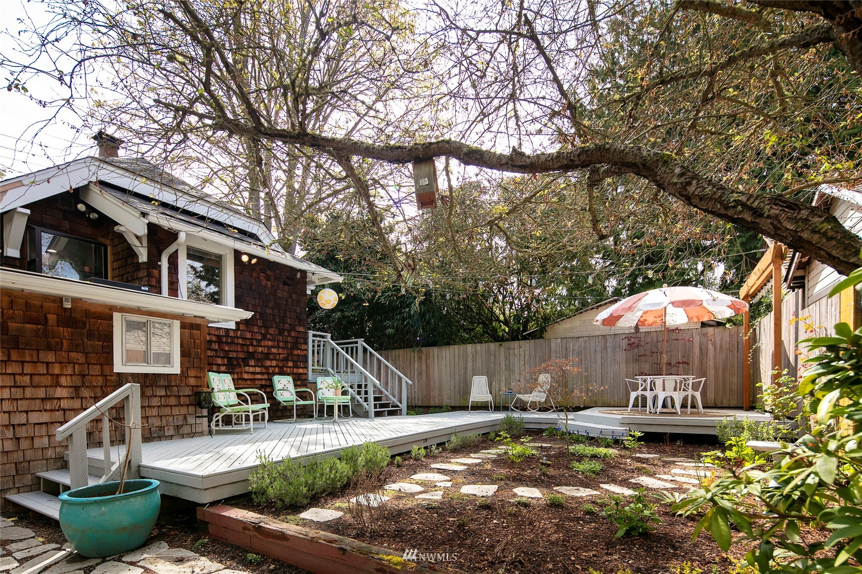 7141 47th Avenue Southwest Seattle, WA 98136 - Photo 21 of 27 a front view of a house with garden and patio