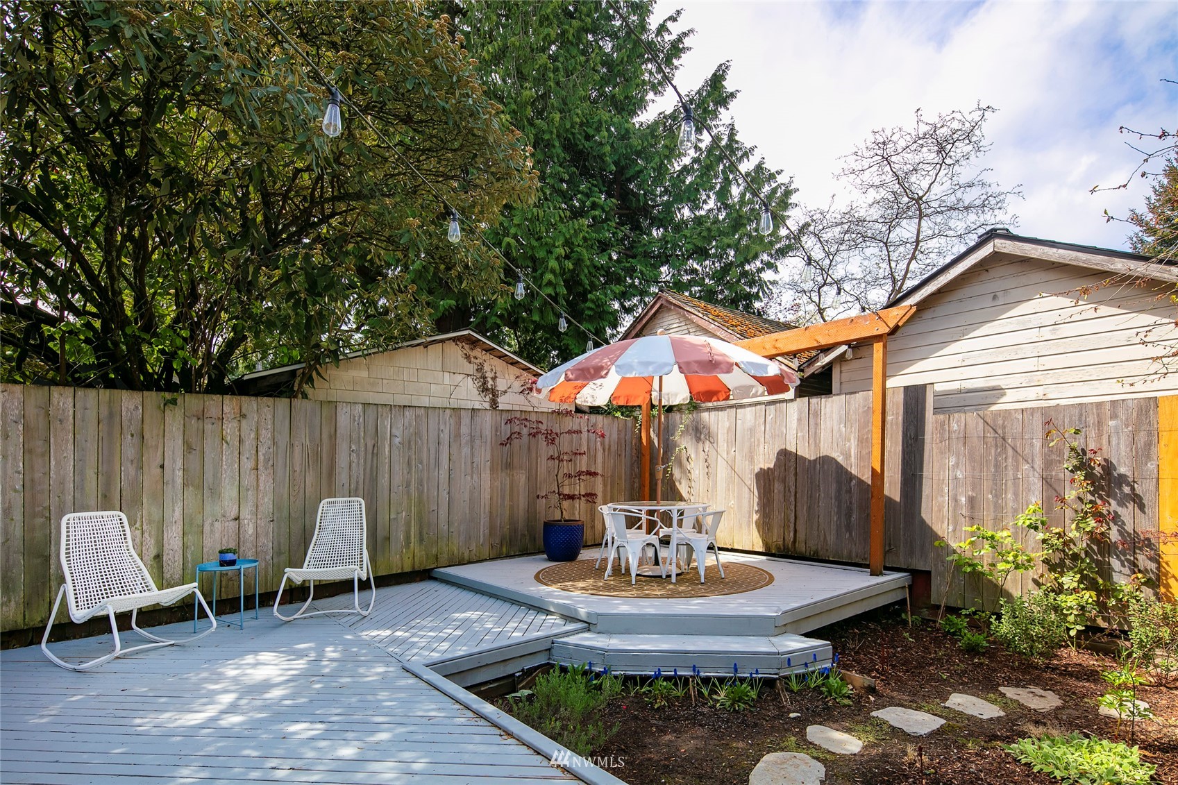 7141 47th Avenue Southwest Seattle, WA 98136 - Photo 22 of 27 a backyard of a house with table and chairs