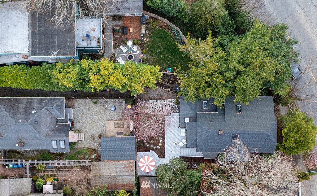 7141 47th Avenue Southwest Seattle, WA 98136 - Photo 26 of 27 an aerial view of a house with a yard and large trees