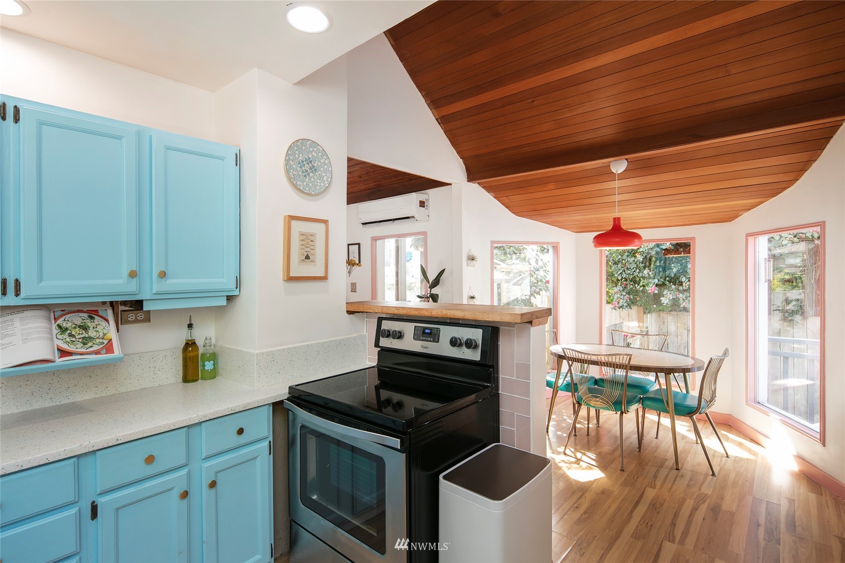 7141 47th Avenue Southwest Seattle, WA 98136 - Photo 6 of 27 a kitchen with a stove a sink and a wooden cabinets