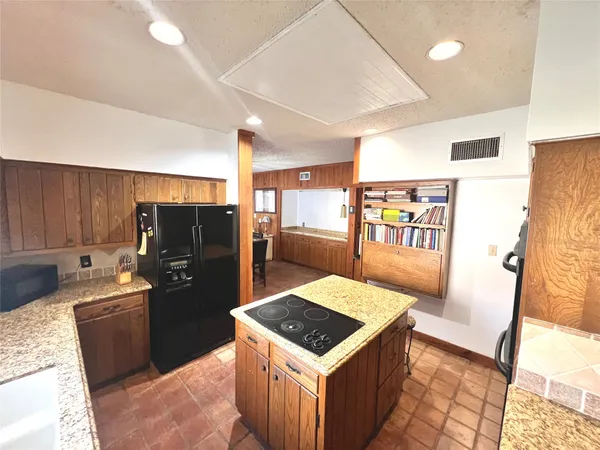 a bathroom with granite countertop a sink and a mirror