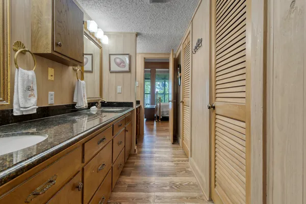 a bathroom with a sink a mirror and shower