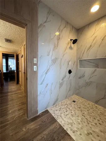 a bathroom with a tub and shower