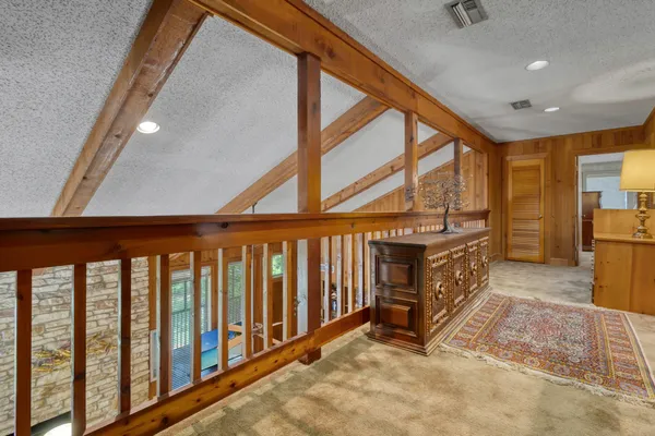 a bedroom with a bed a large window and chair