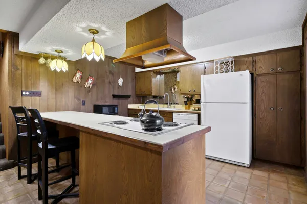 a view of a street with a building and trees in the background